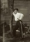 Young “policeman” with billy-club leaning against a tree. EW Carter photo ca. 1900 Split Glass negative: 7″x5″