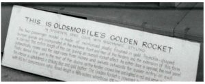 1956 OLDSMOBILE Experimental “Golden Rocket” CLOSE-UP 5″x4″ negative E-4 X23388-53 A lightweight, fiberglass-bodied sports coupe for GM Motorama Oldsmobile Greets NOBLES Of The MYSTIC SHRINE Near Hotel Staler Detroit, Michigan ca. 1956 275-hp “Rocket” V-8 engine Compression Ratio 9.50 to 1 Width 75.4″ Height 49.5″ Wheelbase 105″ Length 201.1″ Front Tread 59″ Rear Tread 56″