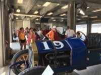 Ragtime Racers looking over a 1911 National Speedway Roadster 2018 6 17 SVRA IMS Ragtime Racers